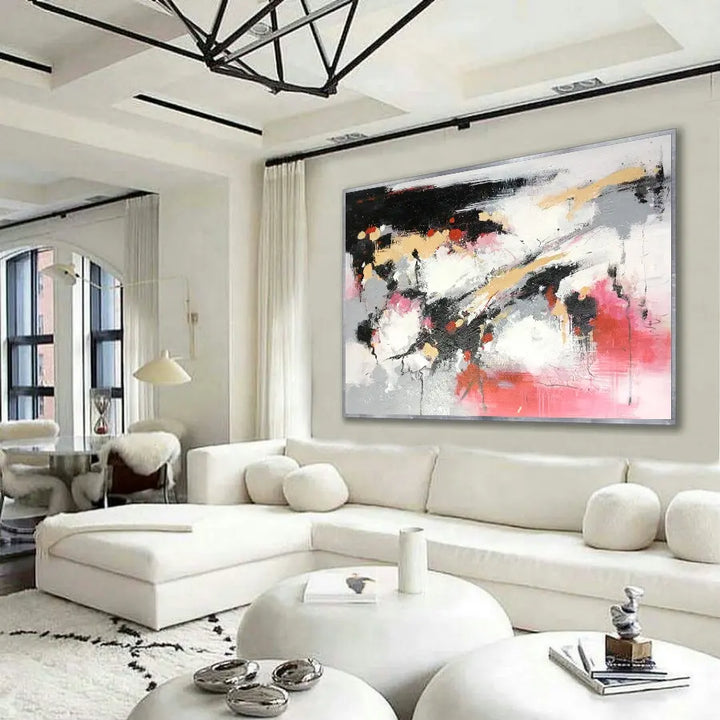 A modern living room with a large abstract painting hanging on the wall.