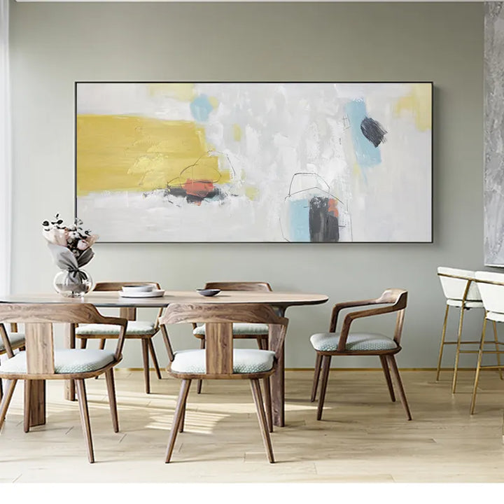 A vibrant abstract painting adorns the wall above a dining table, adding a touch of artistic flair to the space.