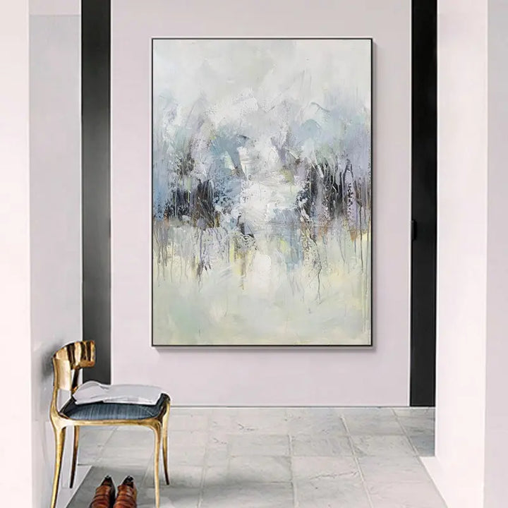 A large painting hanging in a white room, adding elegance and artistic flair to the minimalist space.