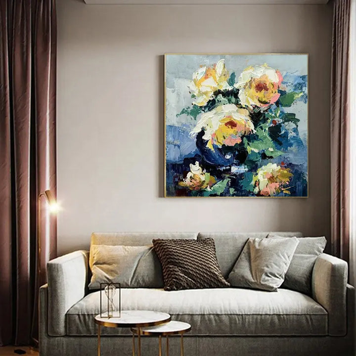 A vibrant painting of yellow roses in a vase, beautifully displayed on a wall.