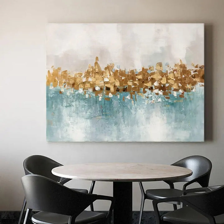 A grand painting adorns the wall above a dining table, adding elegance and charm to the room.