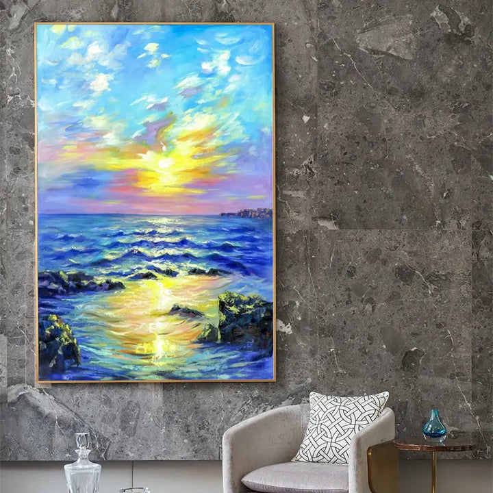 A beautiful painting of a sunset over the ocean, displayed on a wall. The colors are vibrant and the scene is serene.