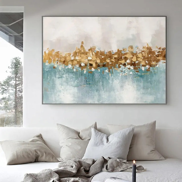 A vibrant abstract painting in gold and blue adorns the wall, adding a touch of elegance and creativity to the space.