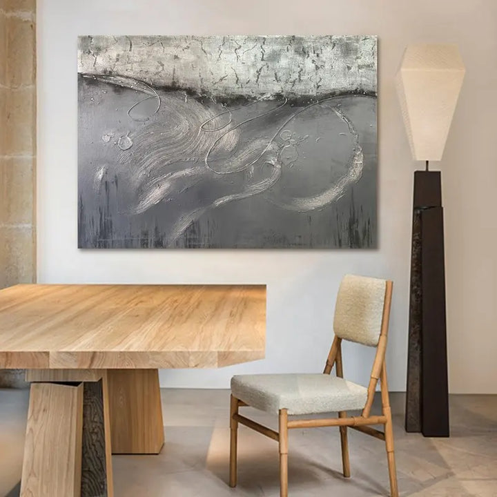 A large painting above a wooden table, adding elegance and charm to the room's decor.