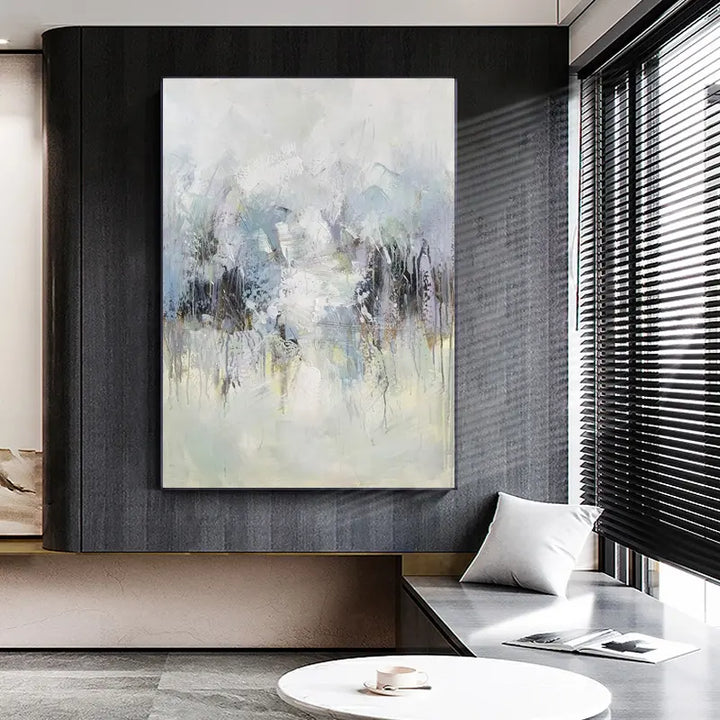 A modern living room with a large hanging painting, creating an artistic and contemporary atmosphere.