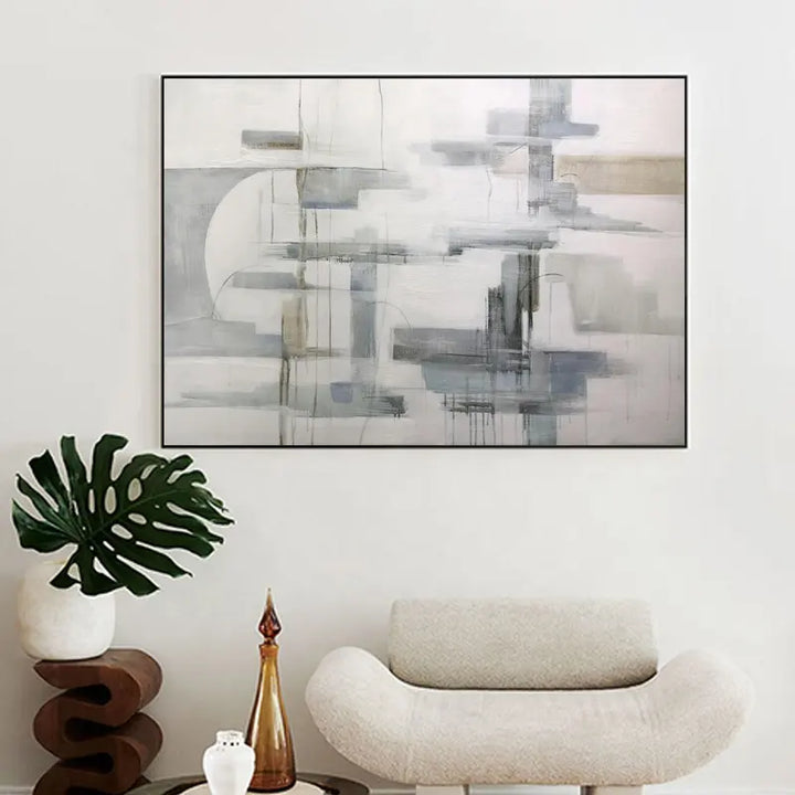 A large abstract painting hanging above a white wall, adding artistic flair to the space.