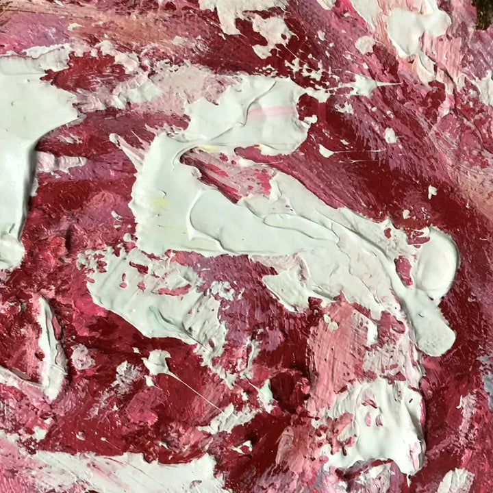 A close-up of a painting with vibrant red and white paint strokes, creating a captivating visual composition.