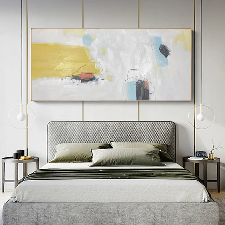 A contemporary bedroom with a sizable painting hanging above the bed.