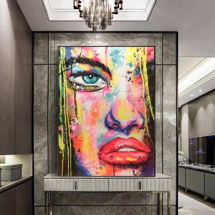 A modern living room showcases a large painting of a woman's face, adding an artistic touch to the space.