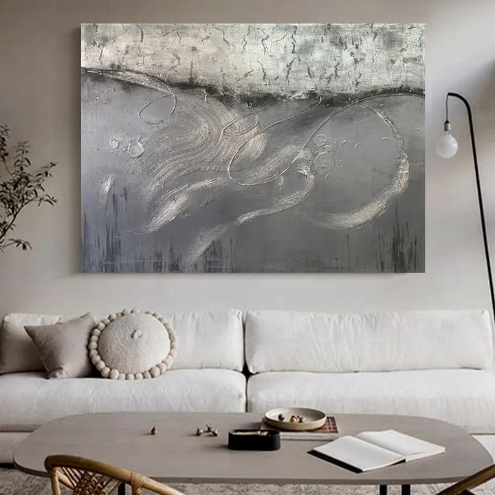 A vibrant abstract painting adorns the wall above a pristine white couch.