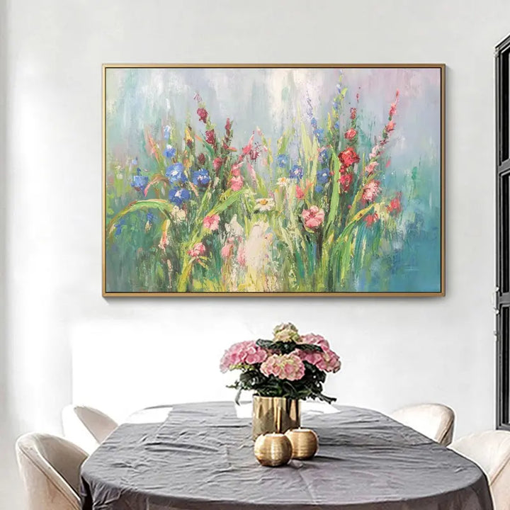 A floral painting hangs above a dining table, adding color and vibrancy to the room's decor.