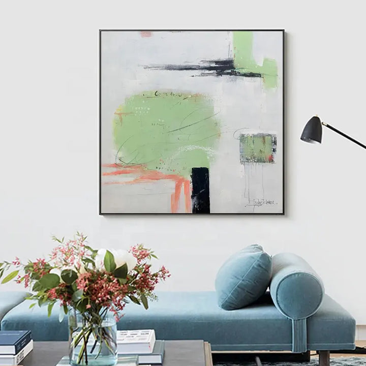 An abstract painting above a blue couch, adding color and artistic flair to the room's decor.