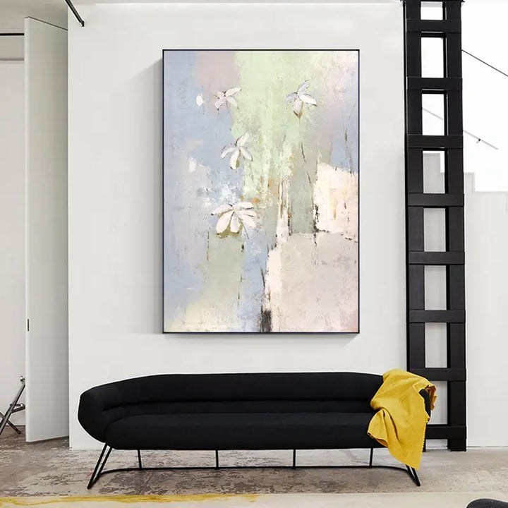 A vibrant abstract painting adorns the wall above a sleek black couch.