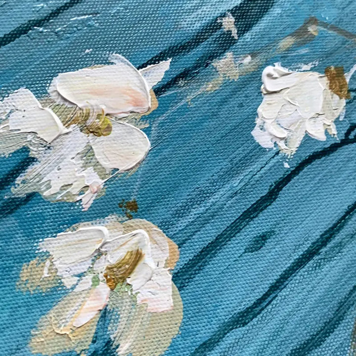 An oil painting of white flowers floating on blue water, creating a serene and tranquil scene.